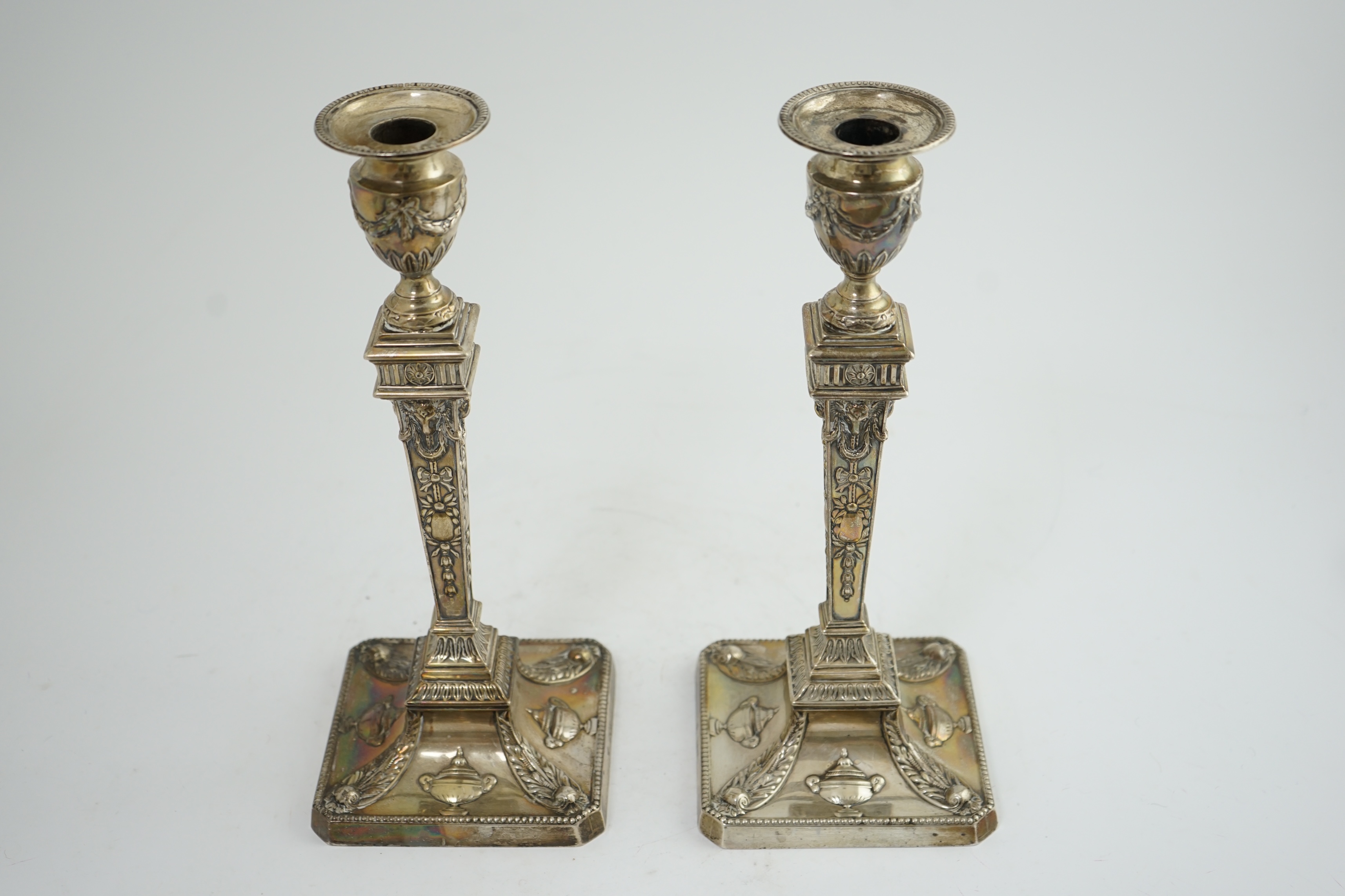 A pair of late Victorian silver Adam style candlesticks, by William Hutton & Sons, (a.f.)